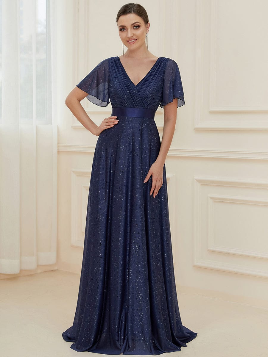 Model wearing a sparkling navy blue A-line V-neck evening dress.