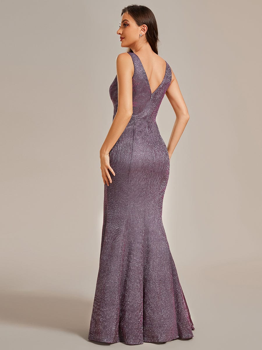 Back view of a woman wearing a red glitter mermaid dress with a train.