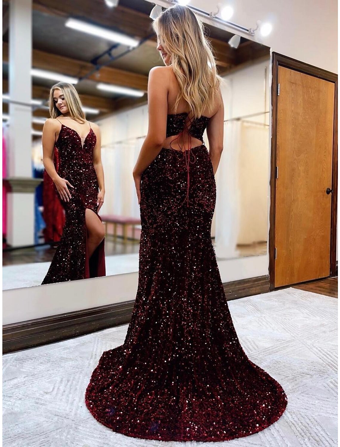 Elegant backless sequined formal gown with a court train and slit.