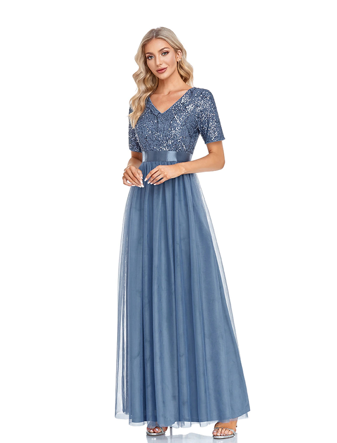 Woman posing in the sparkling navy A-line evening gown, showcasing the floor-length design.
