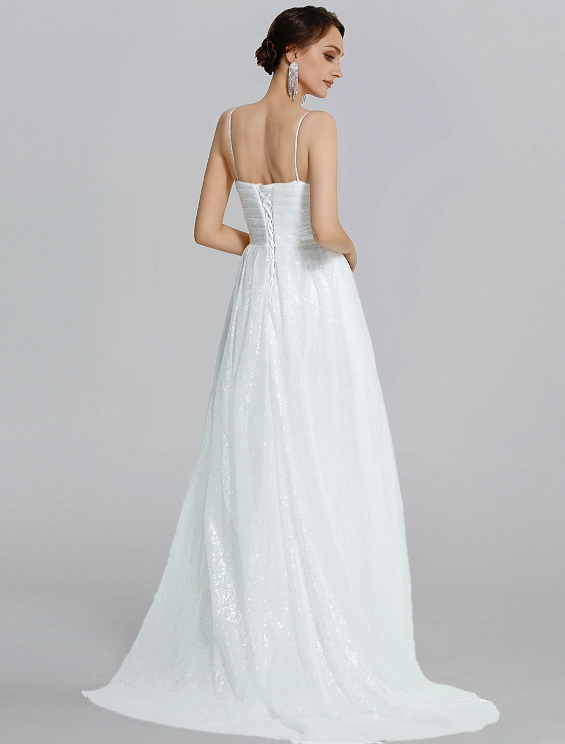 Back view of a woman in a sequined mermaid trumpet gown, showcasing the elegant silhouette.