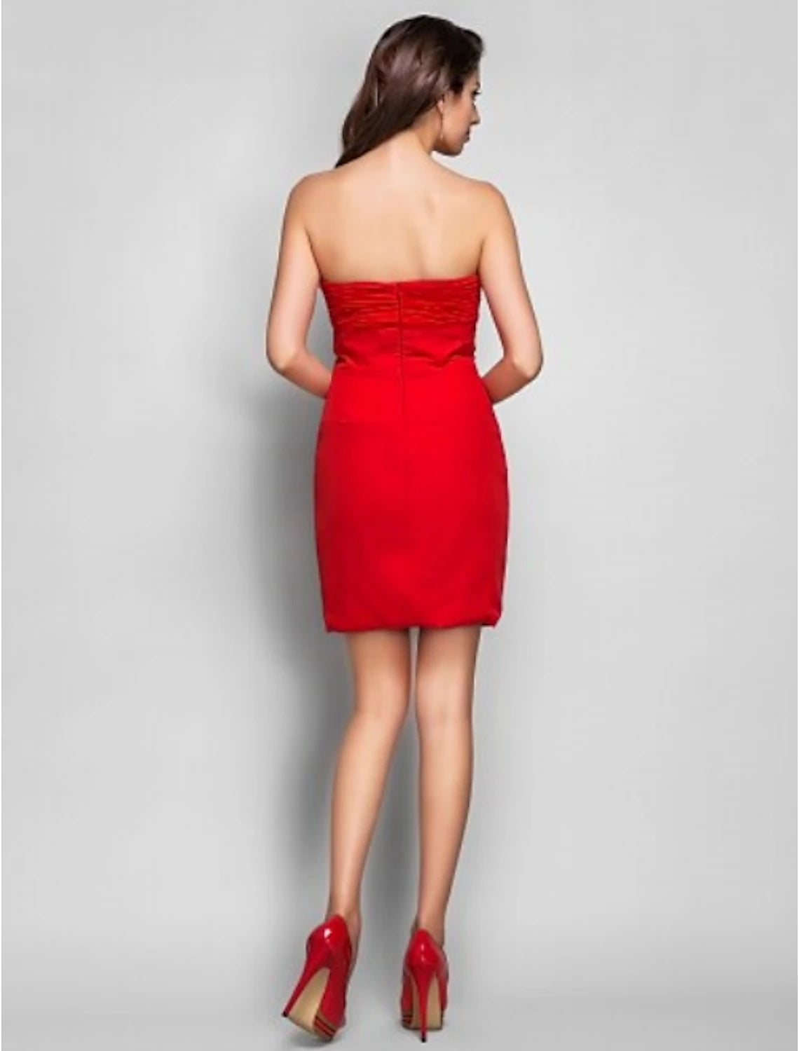 Side view of a woman in a sparkling V-neck ruched chiffon mini cocktail dress.