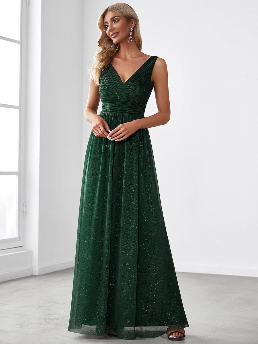Side view of a dark green sparkly double V-neck floor length evening dress.