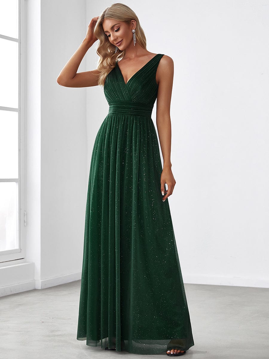 Close-up of the sparkling fabric on a dark green evening dress.