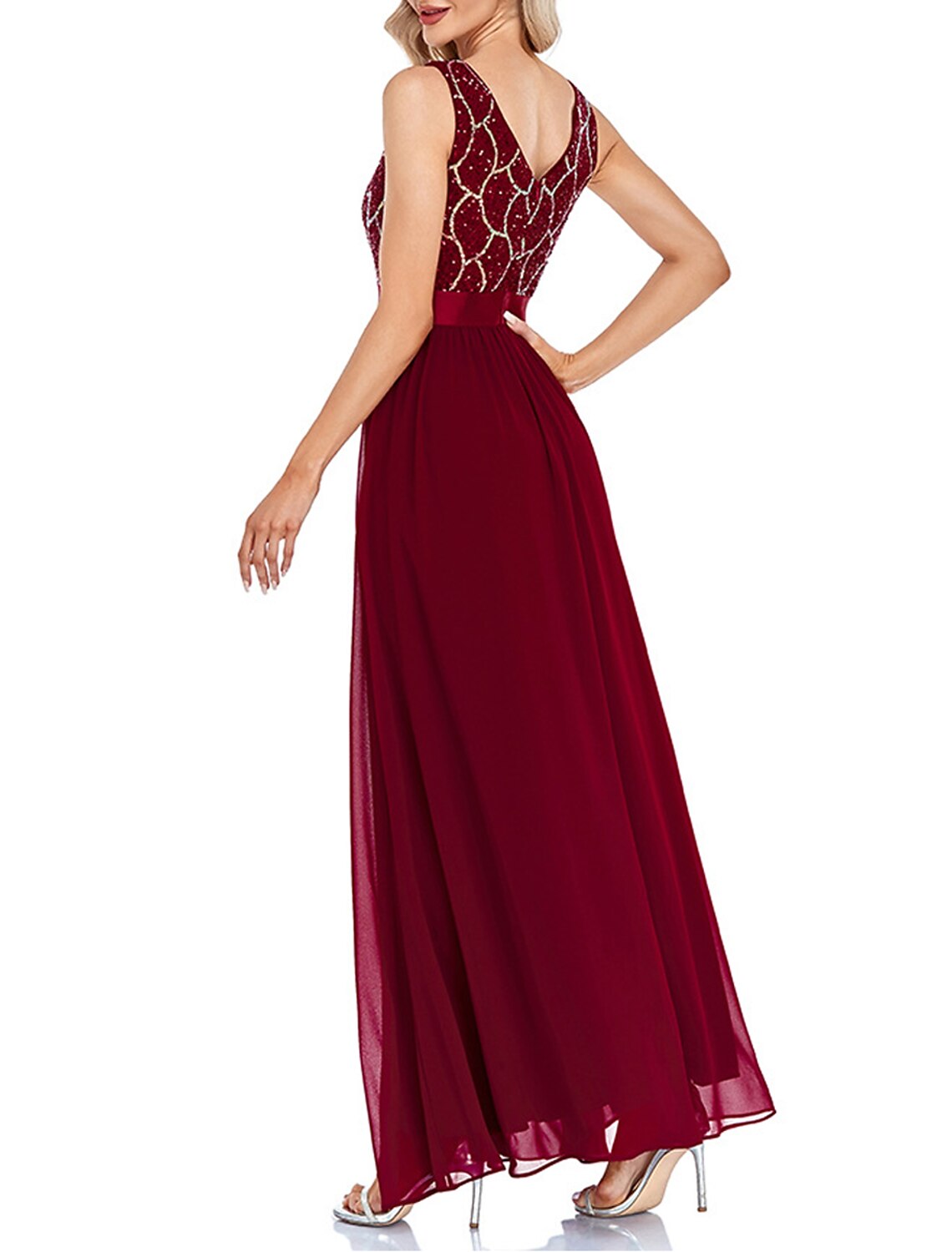Woman wearing a wine sequin V-neck geometric maxi dress, side view.
