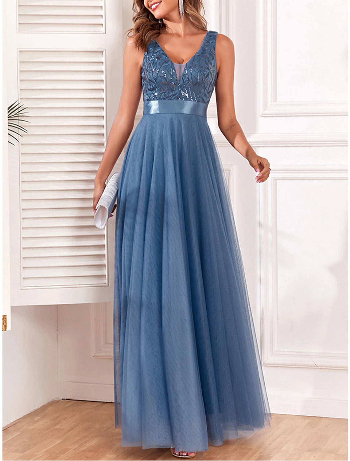 Woman wearing a sparkling blue sequin V-neck maxi dress, front view.