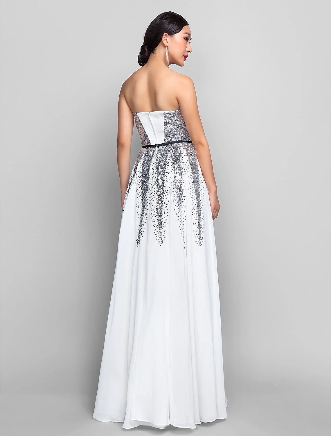 Woman in a pink A-line sweetheart sequin chiffon floor-length dress with a sash.
