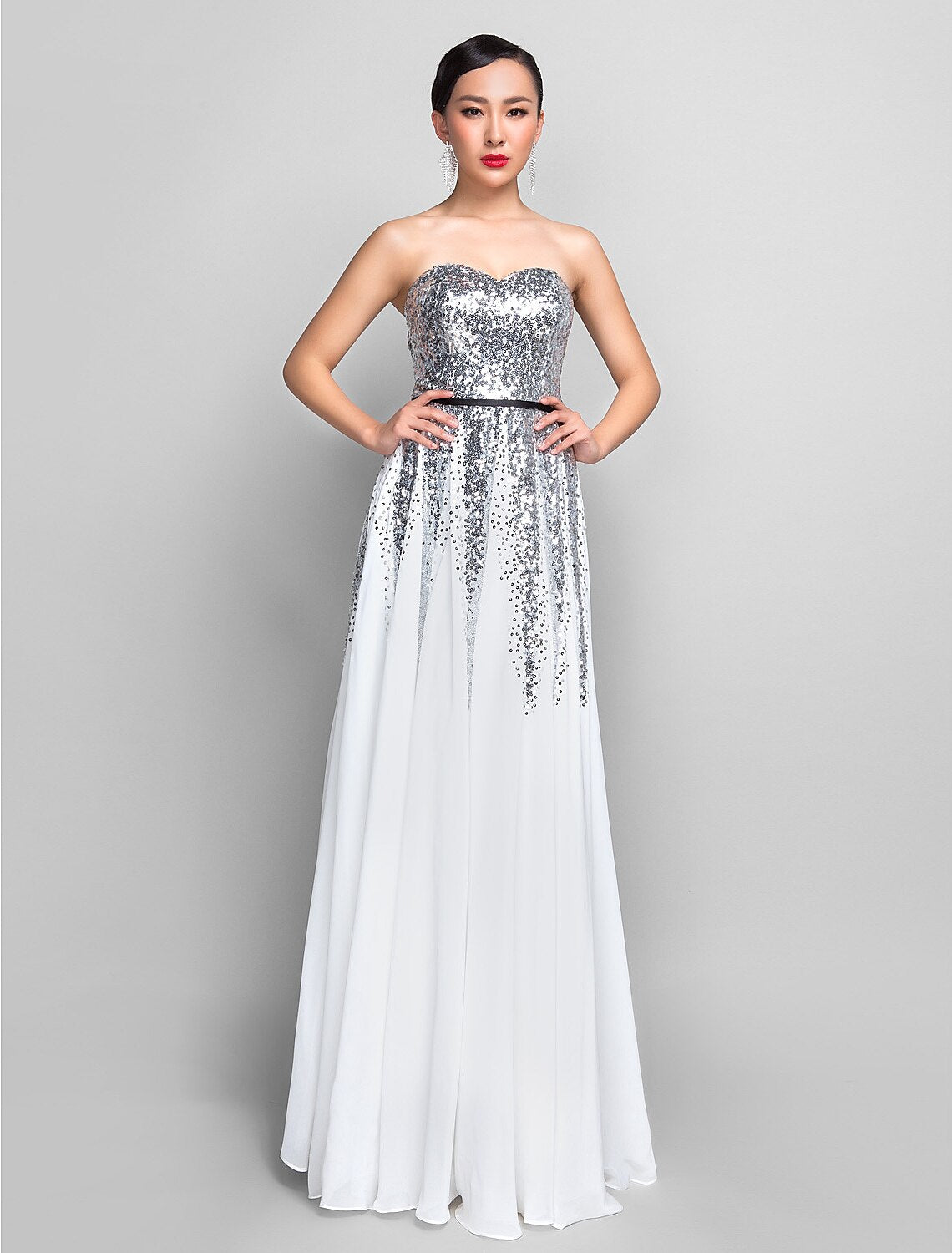 Woman in a purple A-line sweetheart sequin chiffon floor-length dress with a sash.