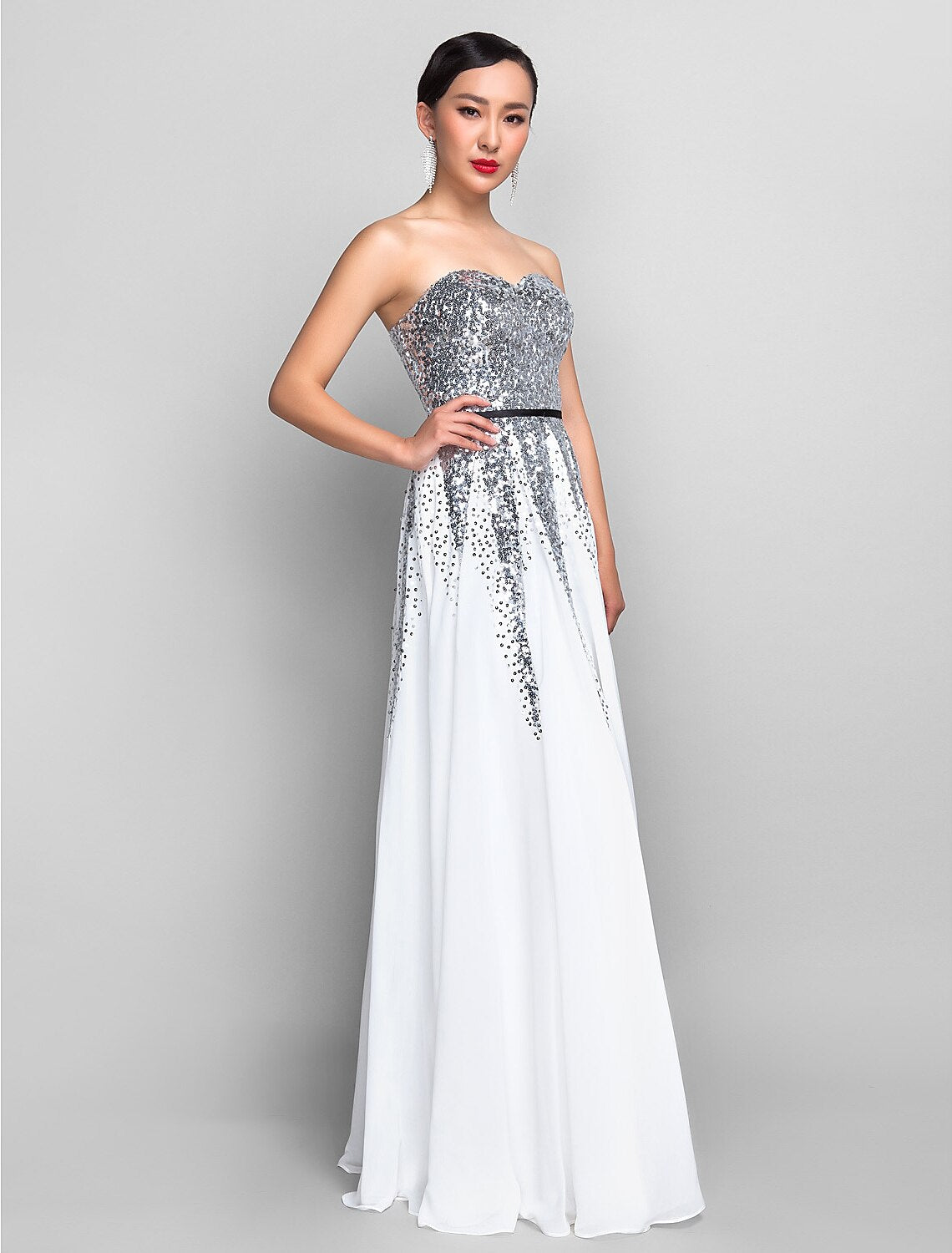 Woman in a red A-line sweetheart sequin chiffon floor-length dress with a sash.