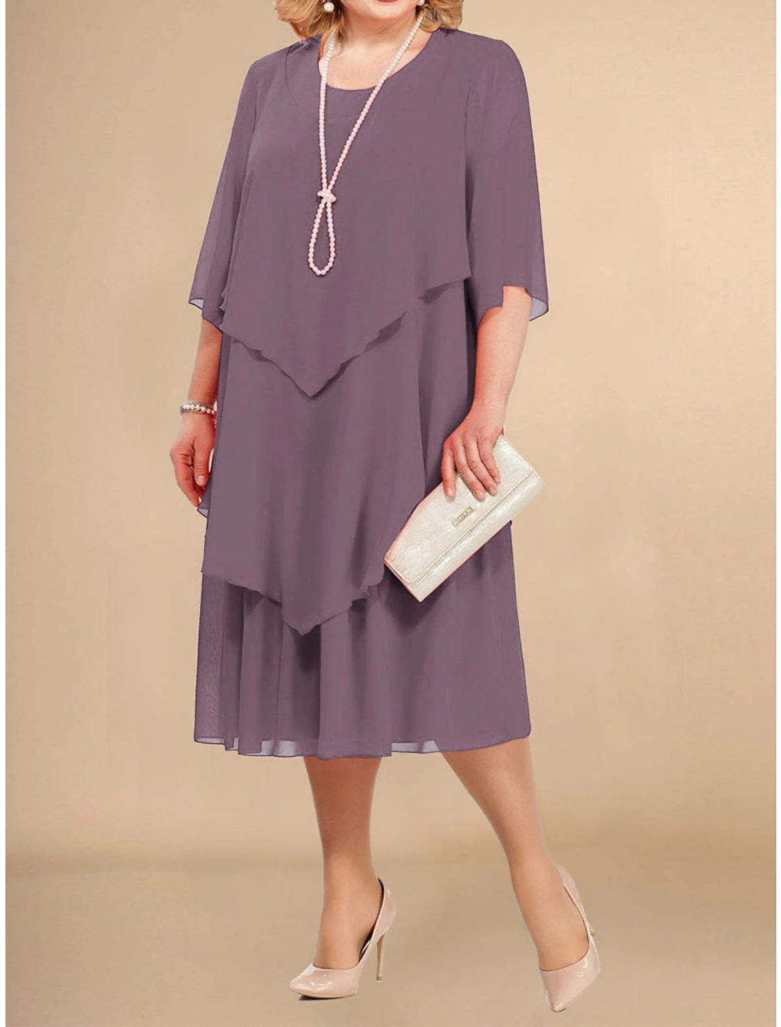 Woman wearing a light purple plus size midi dress with half sleeves and a crew neck, front view.