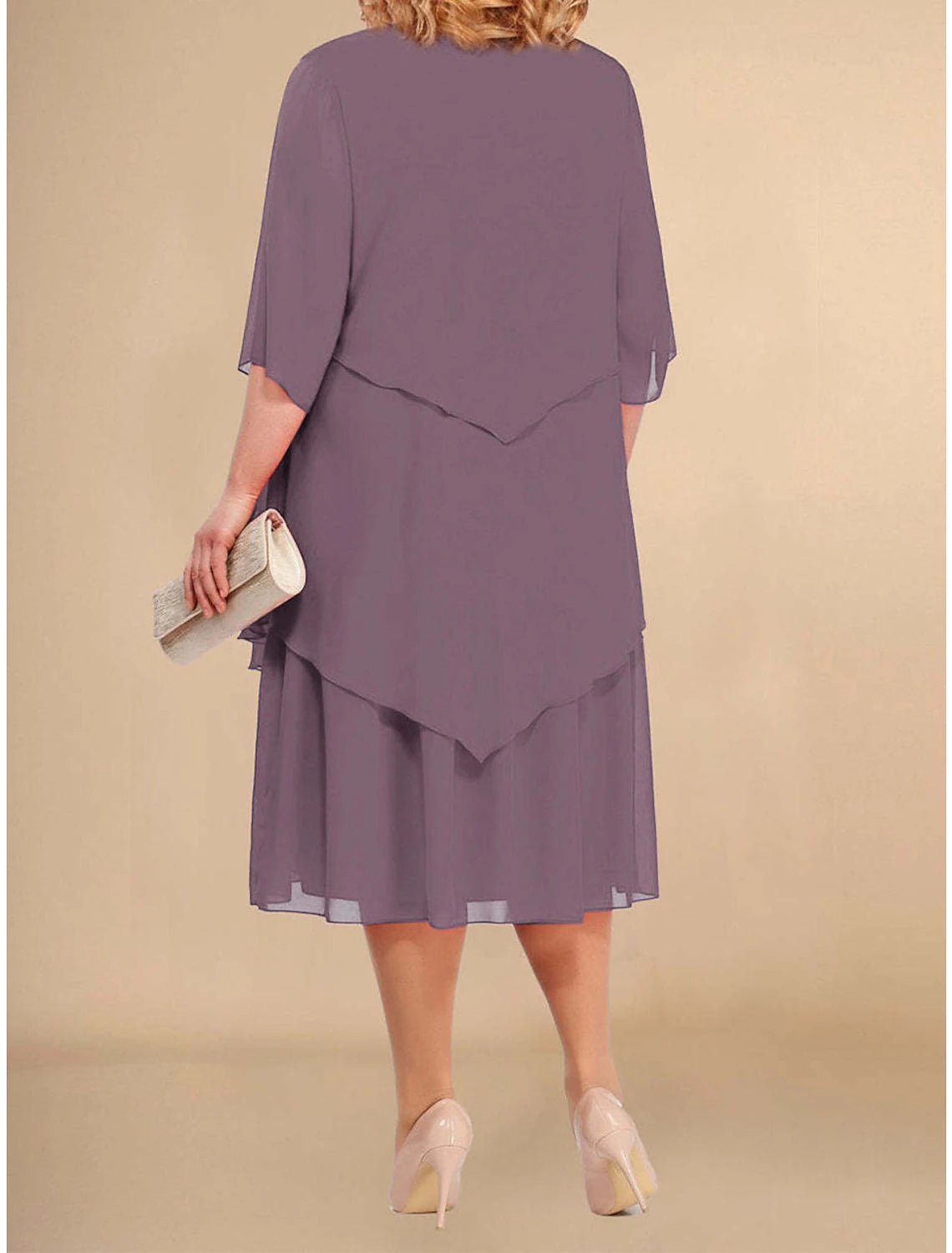 Woman wearing a light purple plus size midi dress, side view, highlighting the layered design.