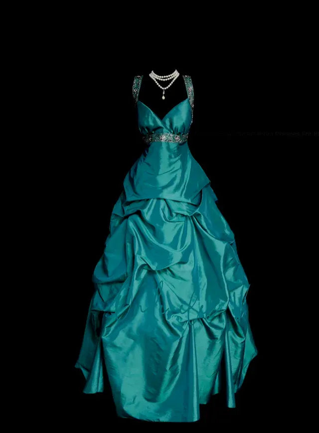 Model wearing a teal satin ball gown with a deep V-neckline and beaded straps, showcasing the front view.