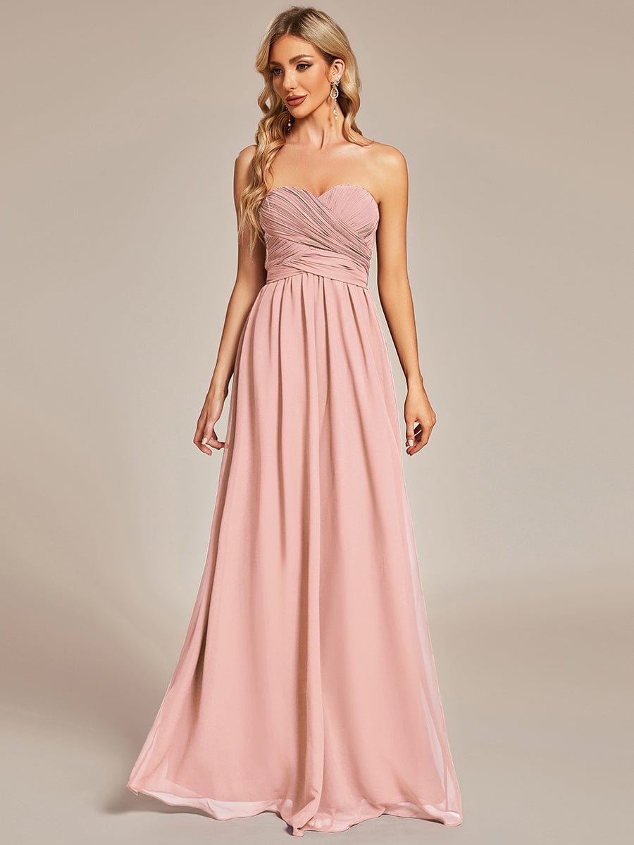 Pink convertible chiffon bridesmaid dress with strapless design and pleated details.