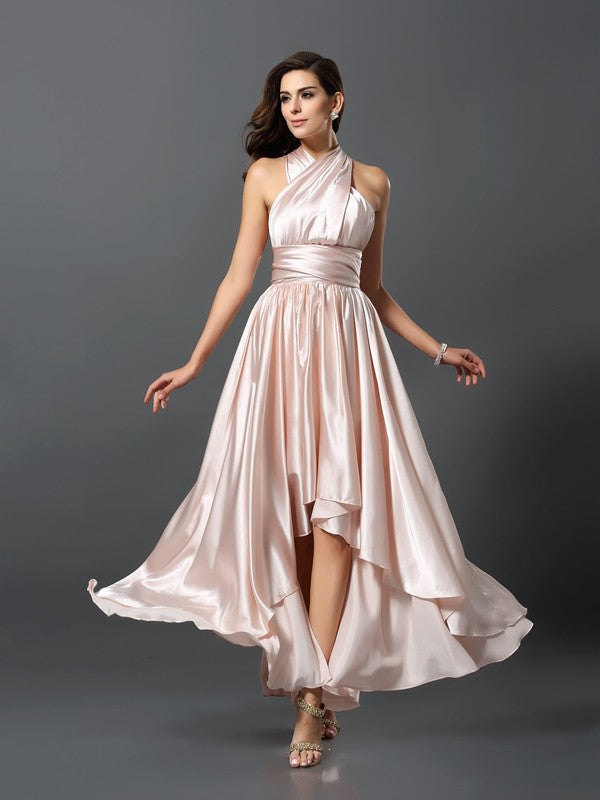 Model posing in a flowing teal high-low bridesmaid gown, highlighting the fabric.