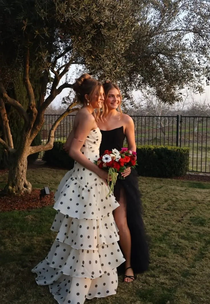 Front view of a woman in a cream polka dot strapless mermaid dress with a sweetheart neckline.