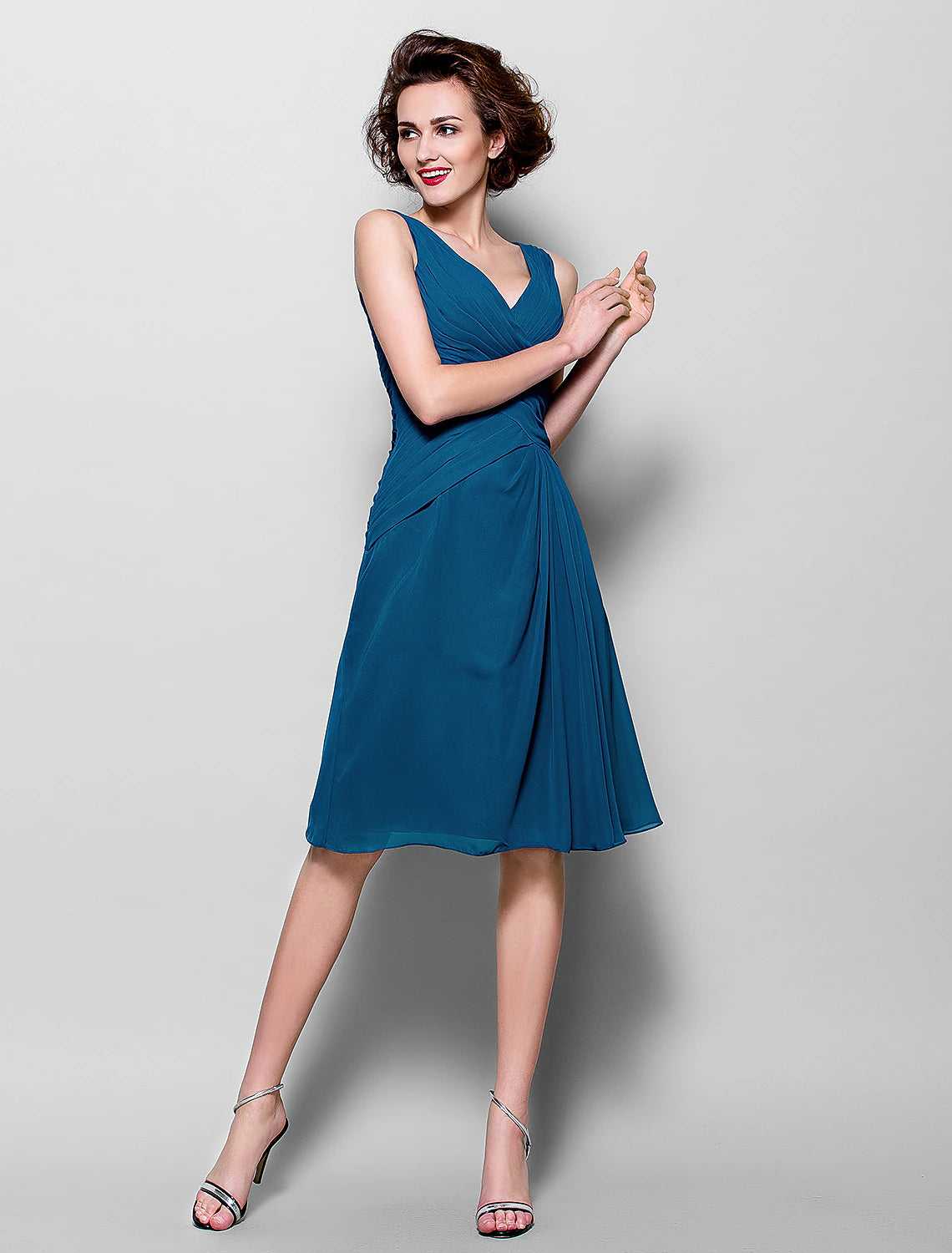Close-up of the V-neckline and 3/4 sleeve detail on the dress.
