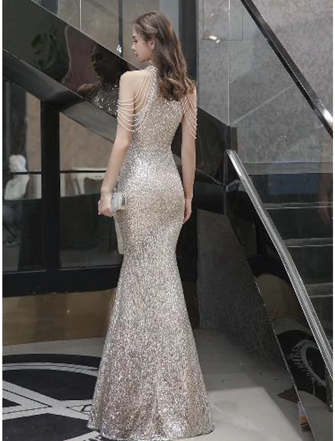 Side view of a woman in a sparkling Weitese bodycon mermaid prom dress with sequin and bead details.