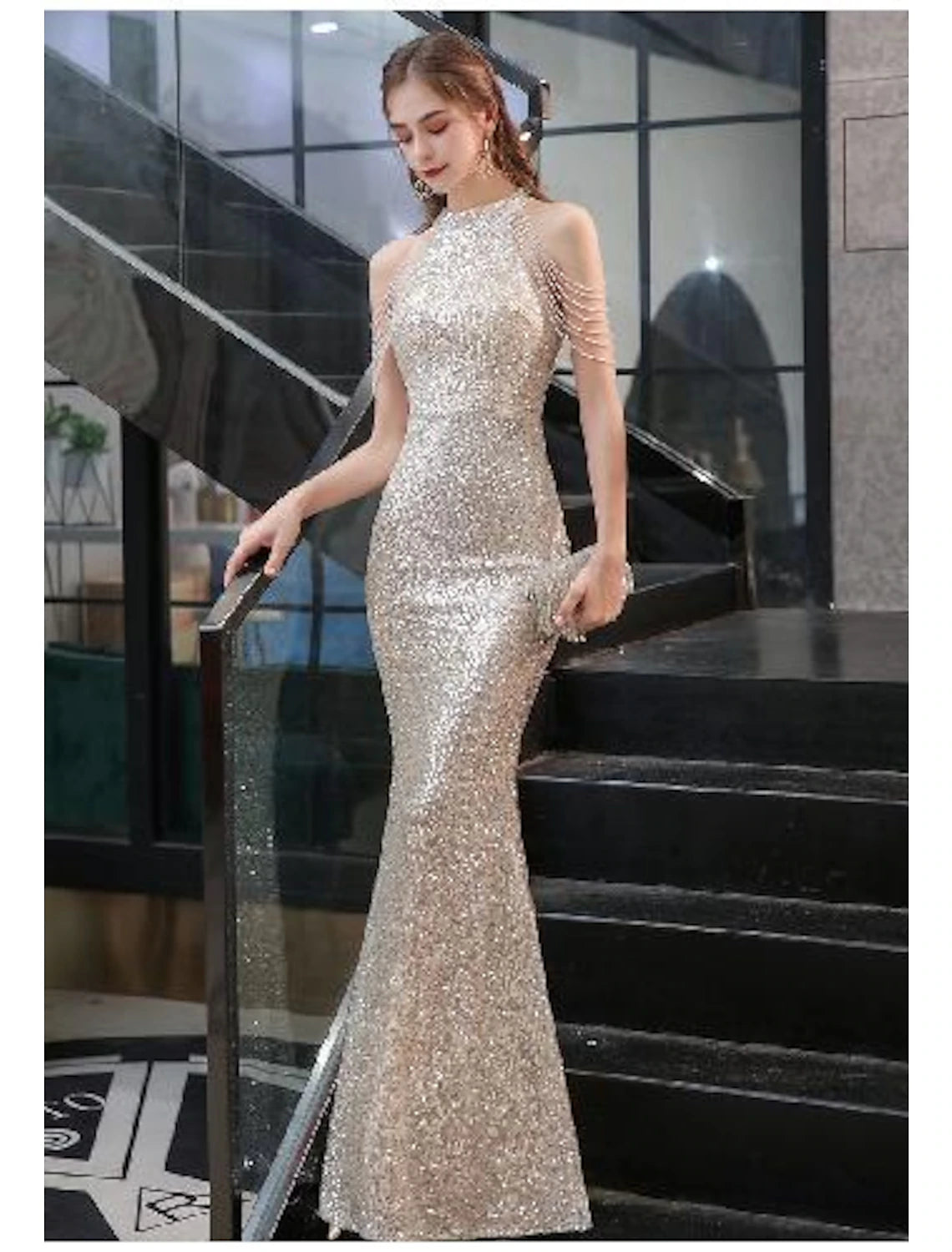 Back view of a woman showcasing the elegant train of a Weitese sequined halter neck formal gown.