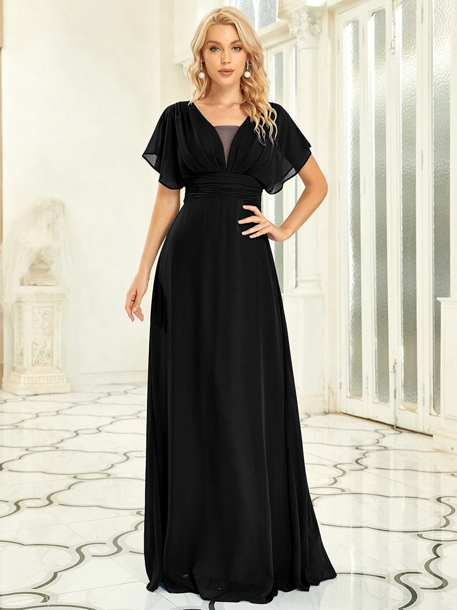 Woman wearing a black Weitese A-line empire waist maxi chiffon dress.