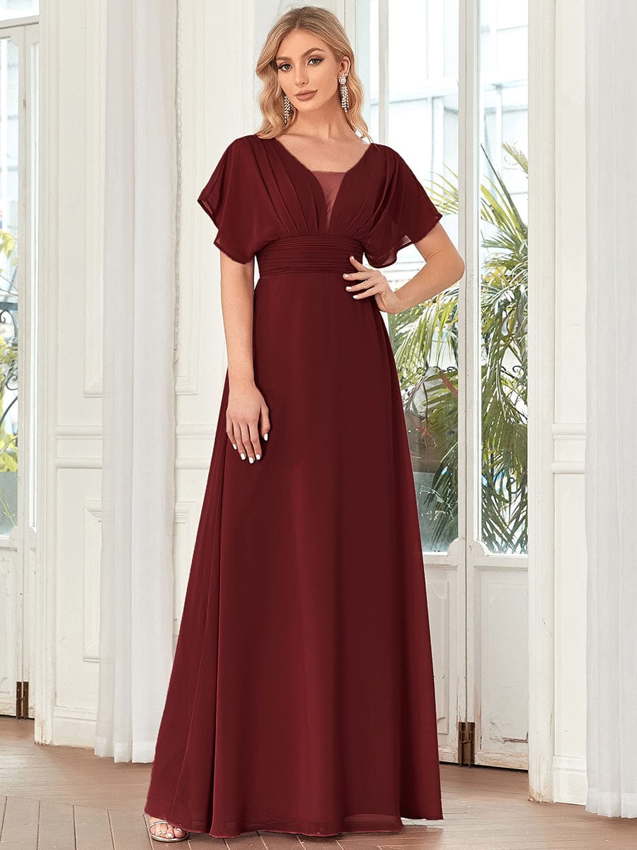 Model showcasing a burgundy Weitese maxi dress with empire waist.
