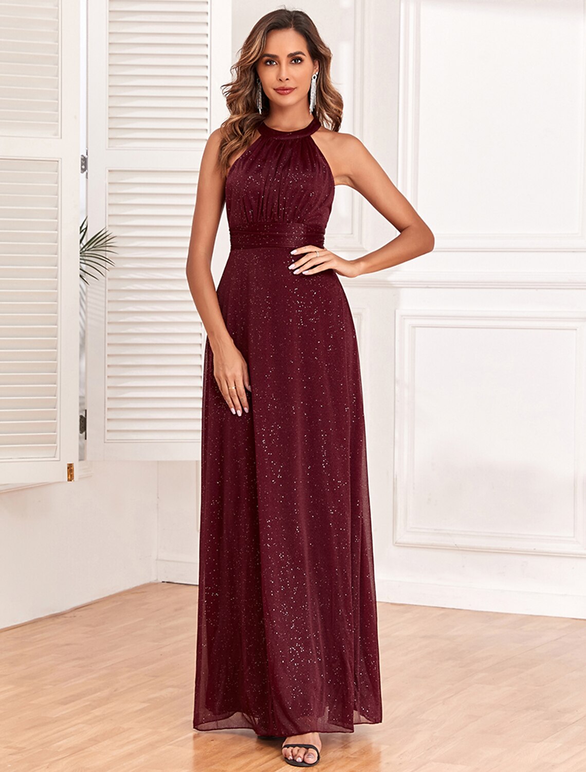 Close-up of the halter neck and backless V-back on the glitter gown.