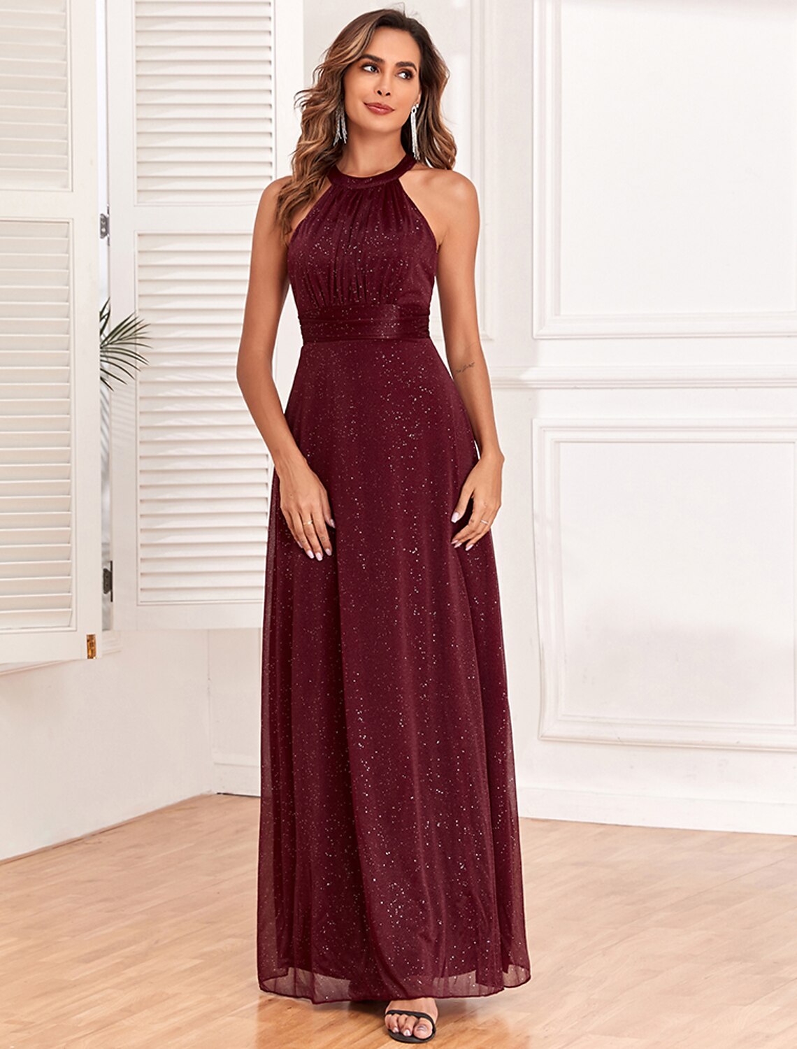 Model wearing Weitese floor-length glitter gown, side view.
