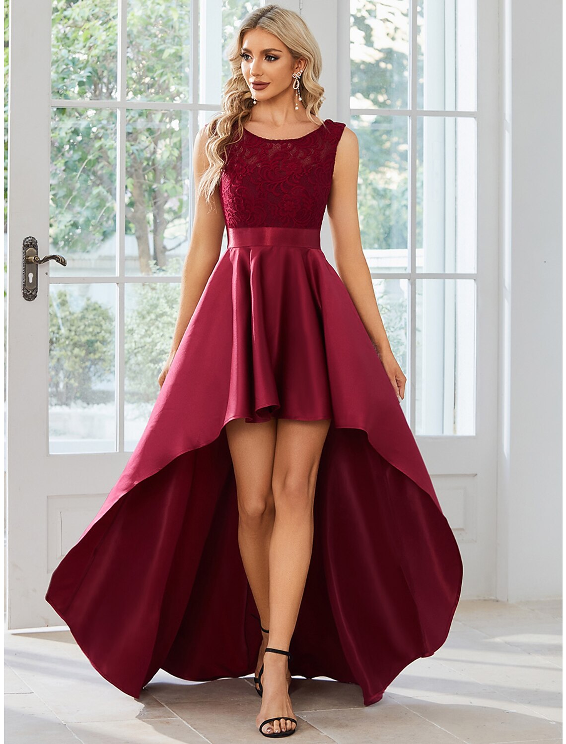 Full-length view of a woman wearing a solid color A-line satin dress.