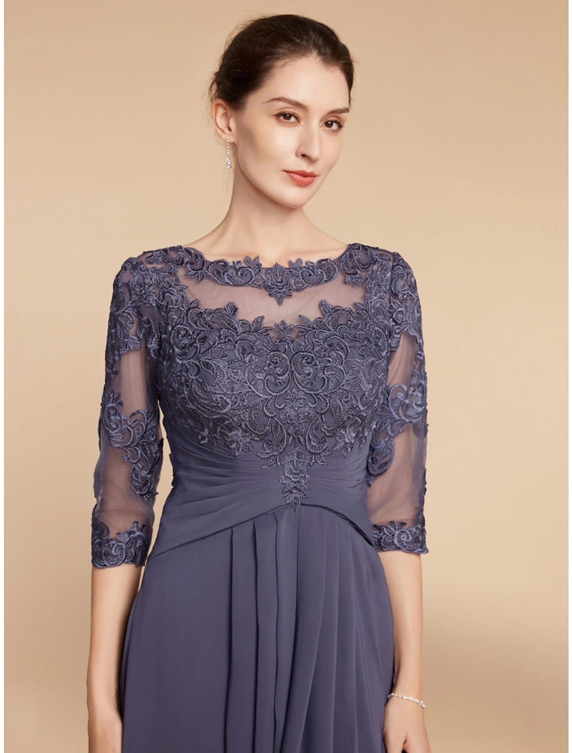 Model wearing elegant A-line dress for a wedding.