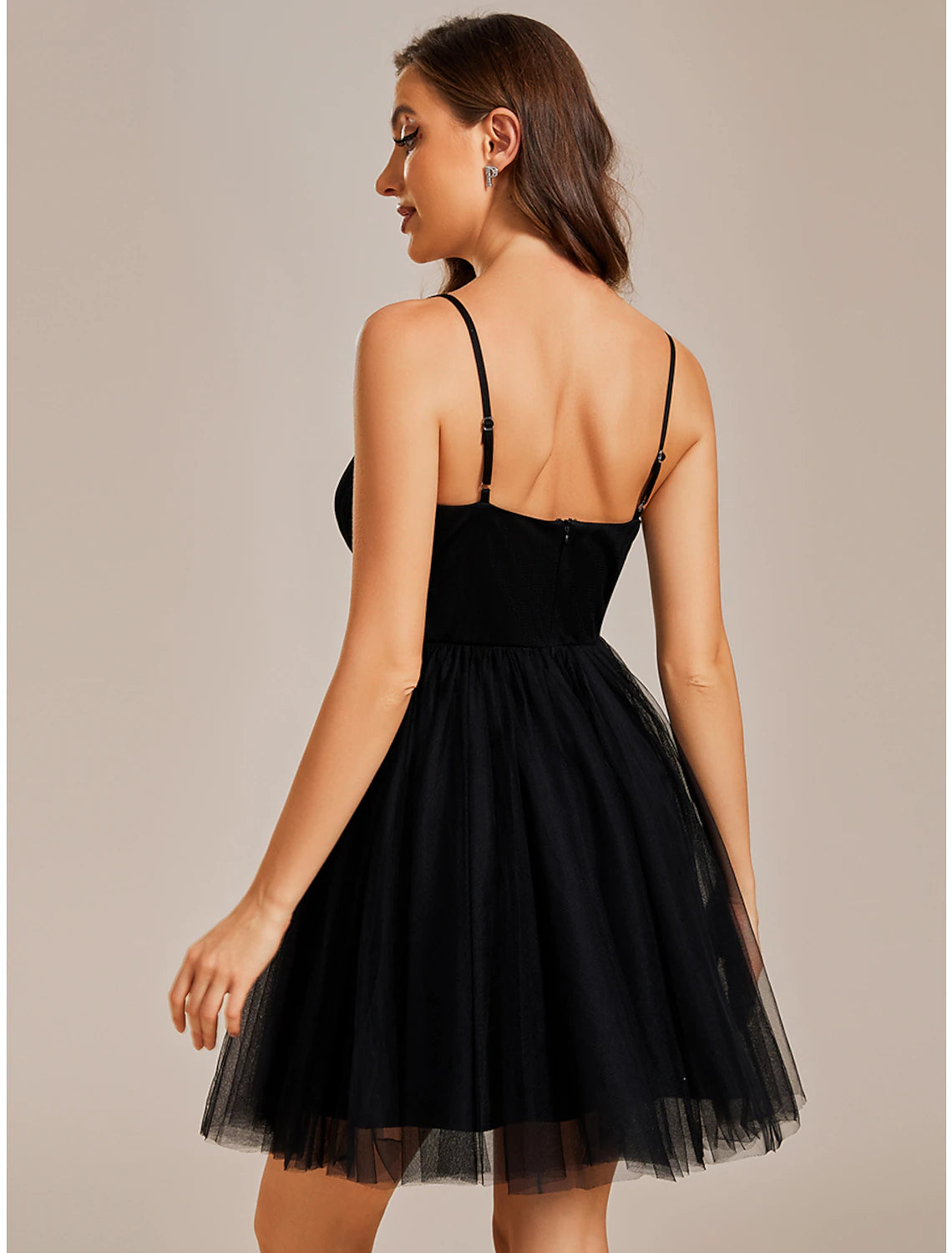 Model in a blue Weitese A-line mini dress, showcasing the back and ruched details.