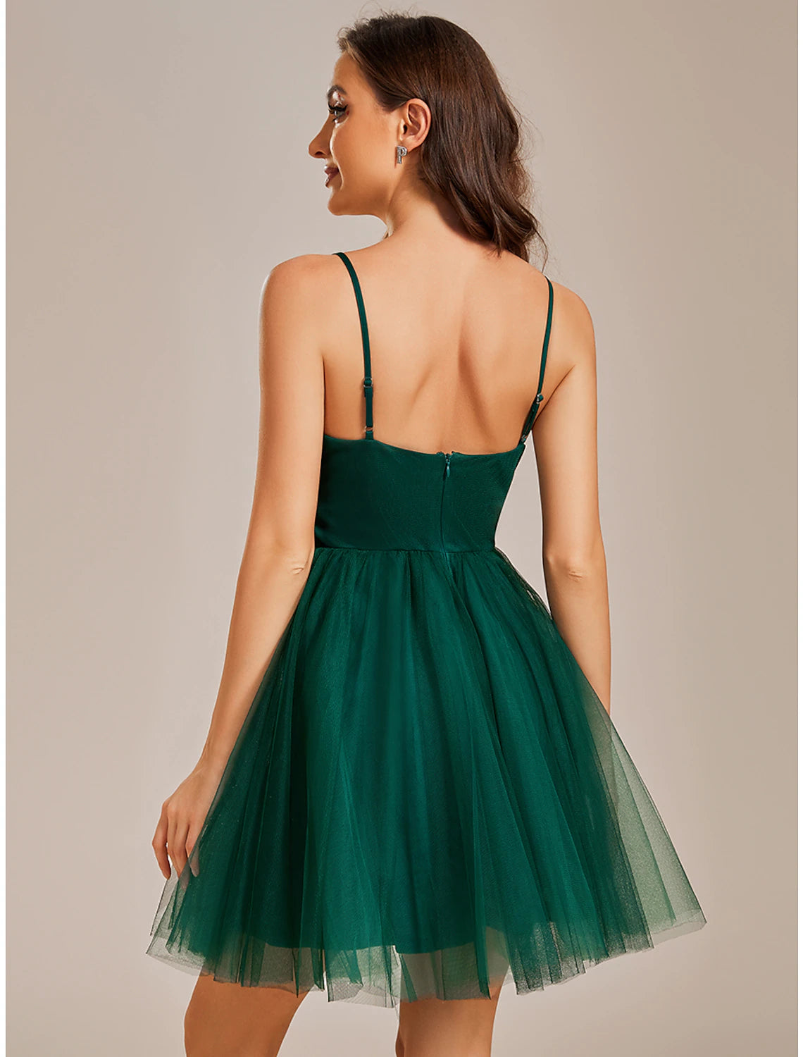 Side view of a model wearing a black Weitese A-line mini dress with delicate straps.