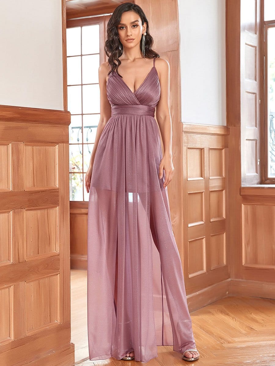 Woman wearing an olive green Weitese spaghetti strap sheer bridesmaid dress.