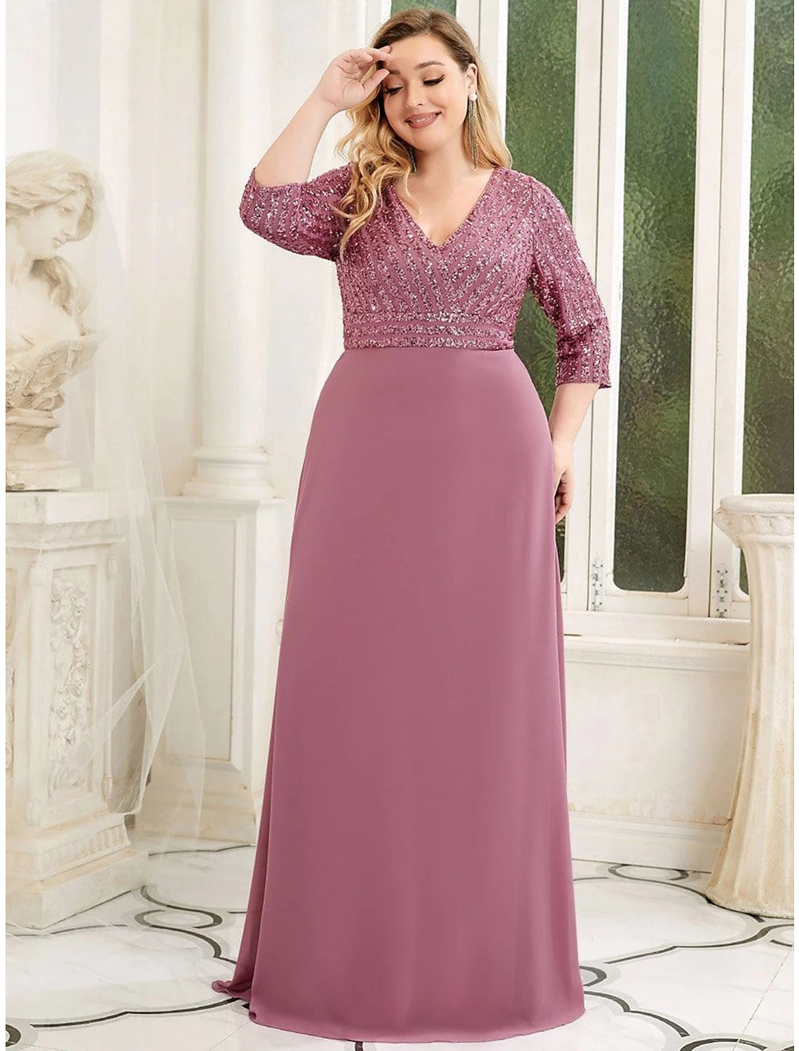 Woman wearing a dark A-line V-neck sequin chiffon evening gown.