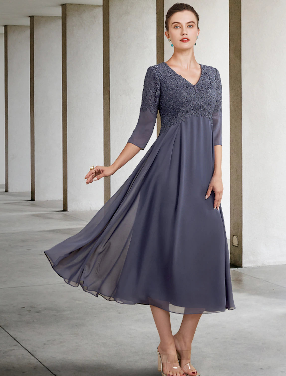 Elegant A-line V-neck chiffon lace tea length dress with 3/4 sleeves on a model.