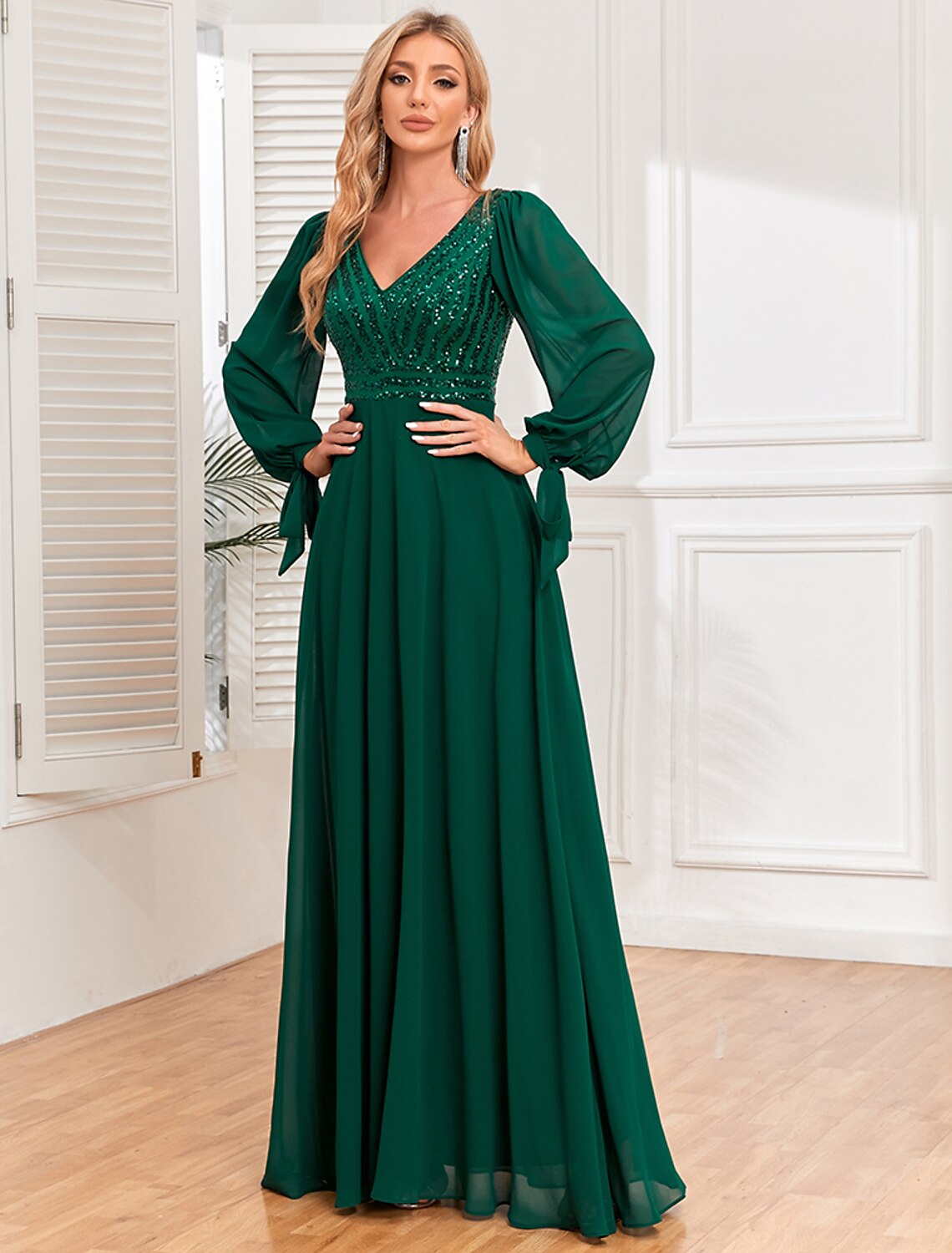 Woman wearing a Weitese elegant A-line V-neck long sleeve sequin chiffon evening gown.