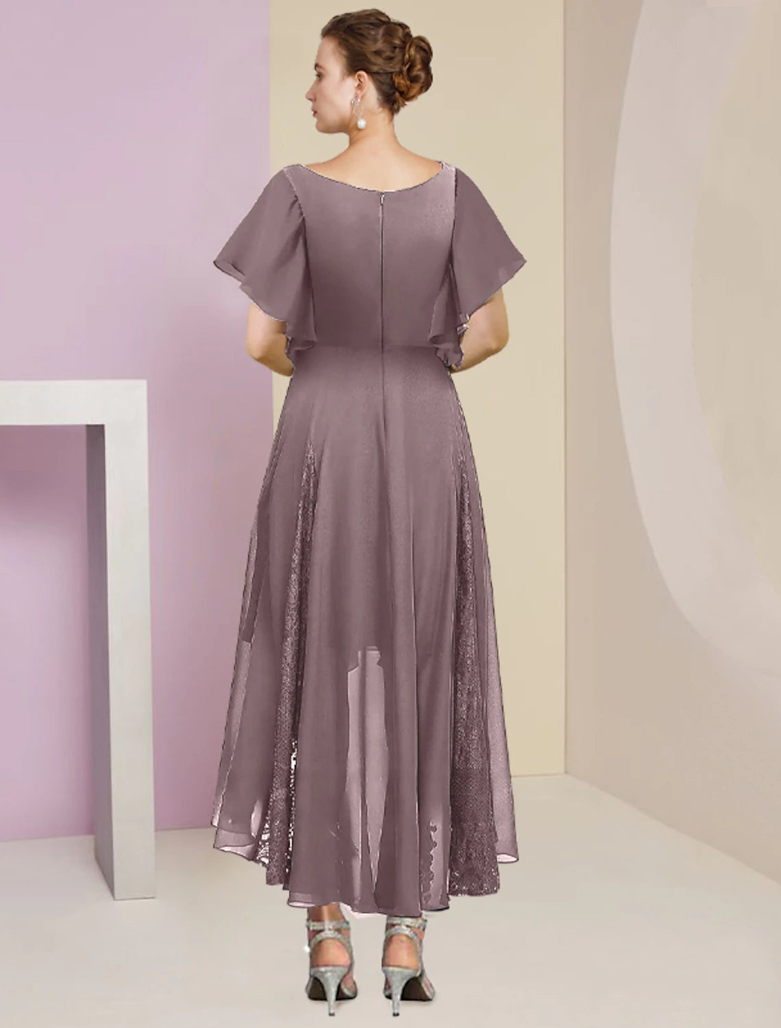 Close-up of the Weitese chiffon lace dress with pleats and crystal brooch.