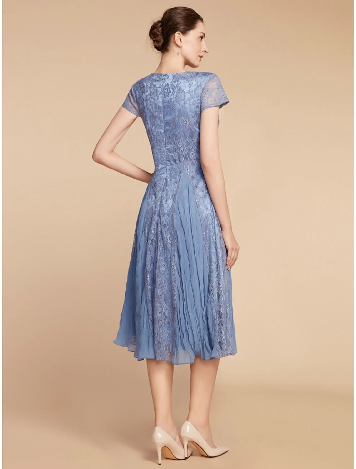 A woman posing in the Weitese chiffon lace ruched dress, showing the back detail.