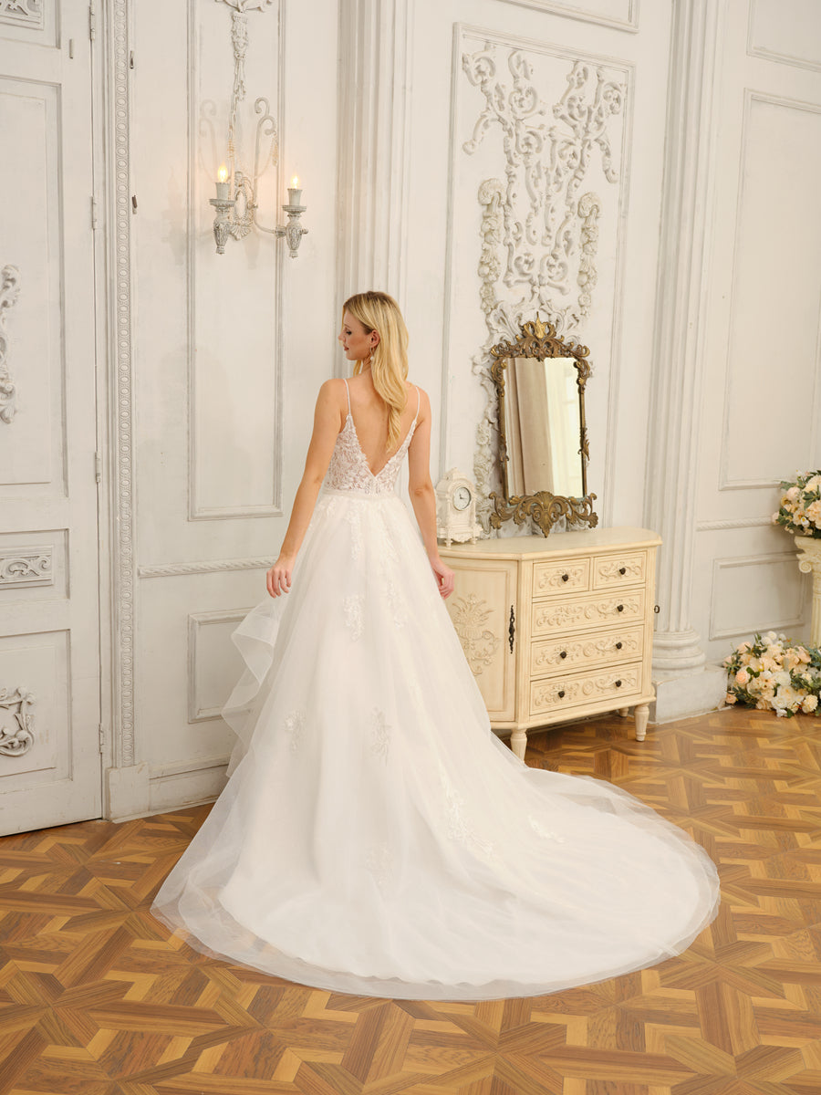 Side view of the Weitese long wedding dress, highlighting the appliques and flowing skirt.