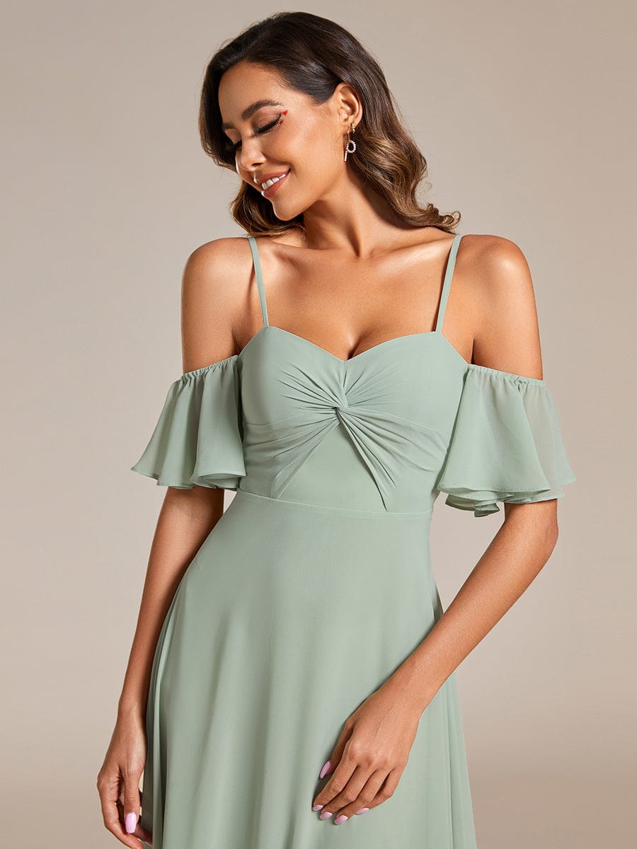 Close-up of the knot detail on a green Weitese chiffon bridesmaid dress.