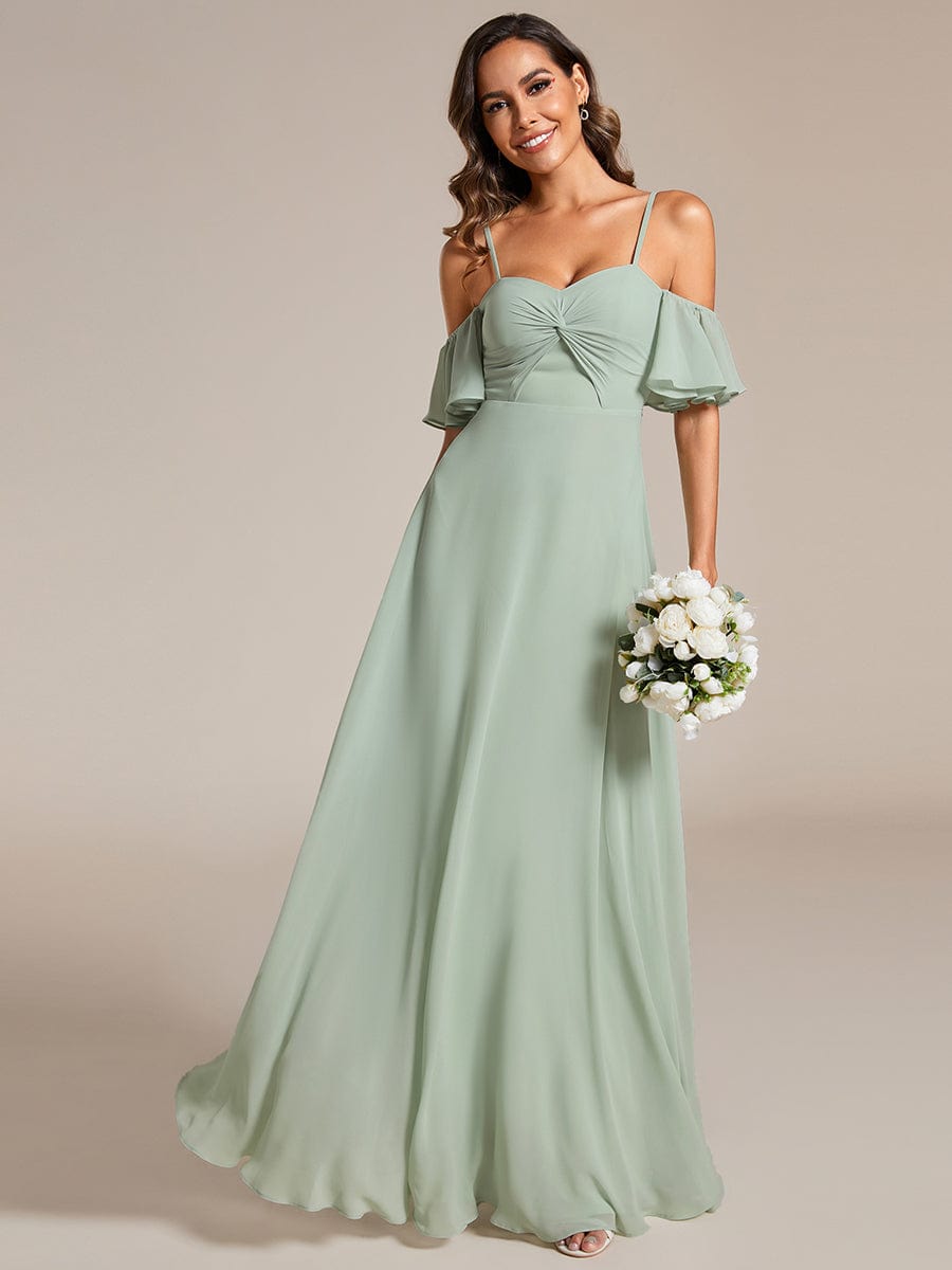 Side profile of a model in a green Weitese A-line chiffon dress.