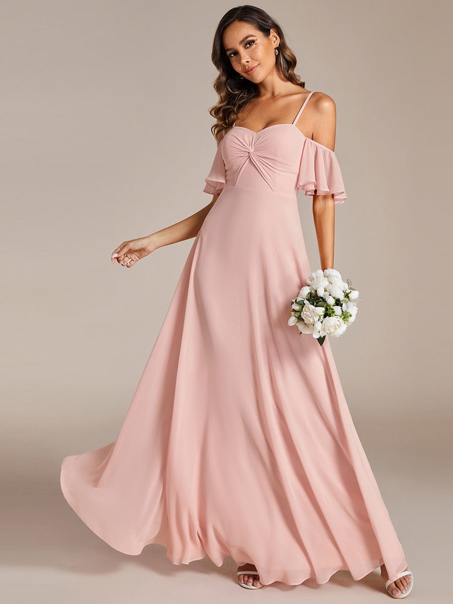 Model in a pink Weitese A-line chiffon bridesmaid dress with spaghetti straps.