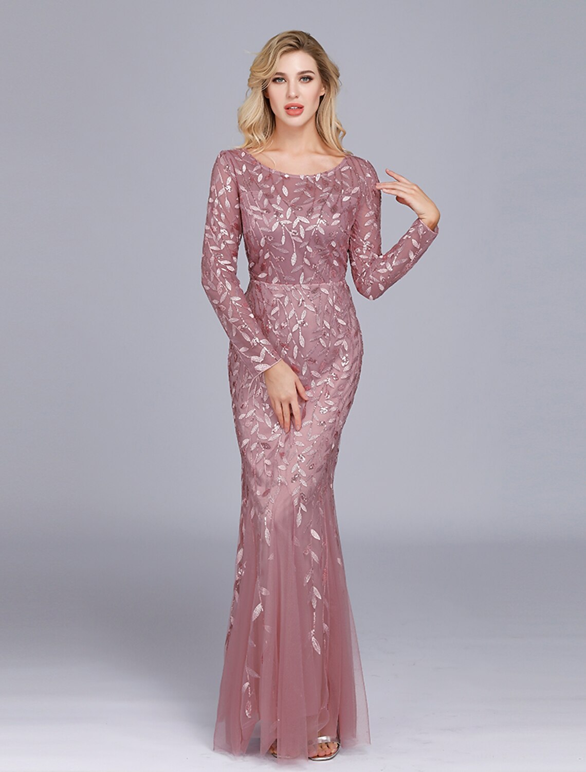Full-length view of a woman wearing the light-colored Weitese embroidered mermaid gown.