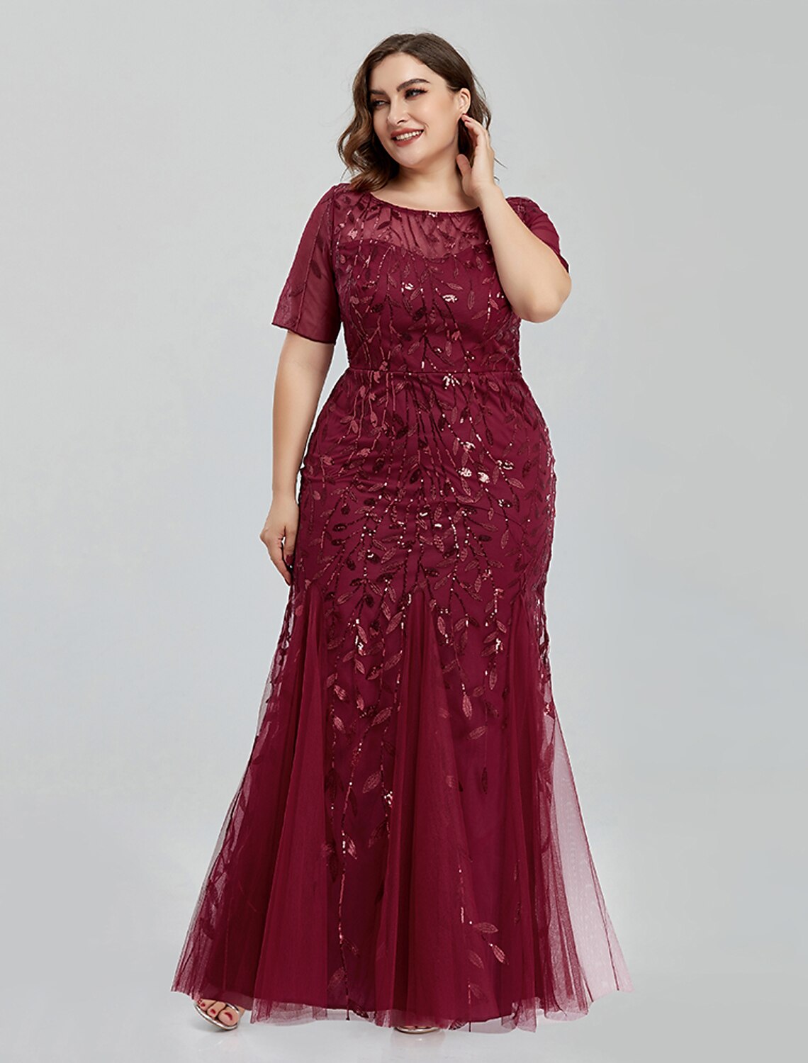 Woman wearing a Weitese elegant embroidered tulle mermaid trumpet evening gown.