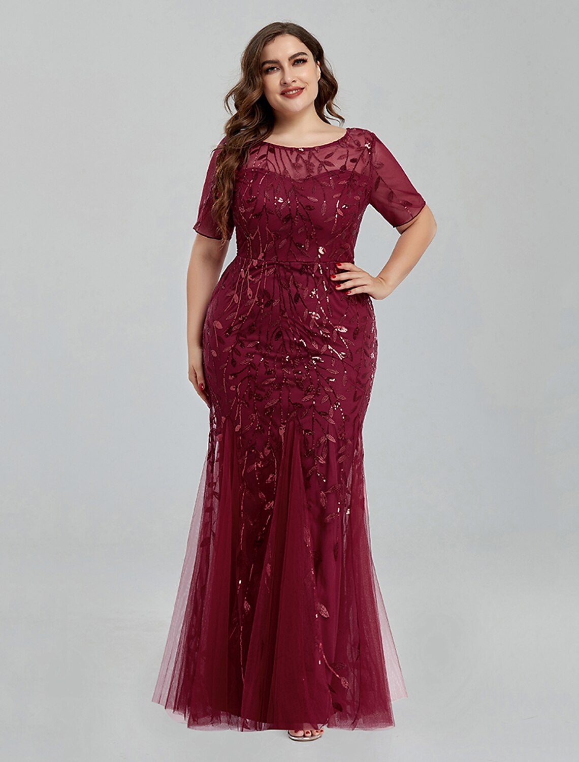 Back view of a Weitese mermaid trumpet evening gown with intricate embroidery.