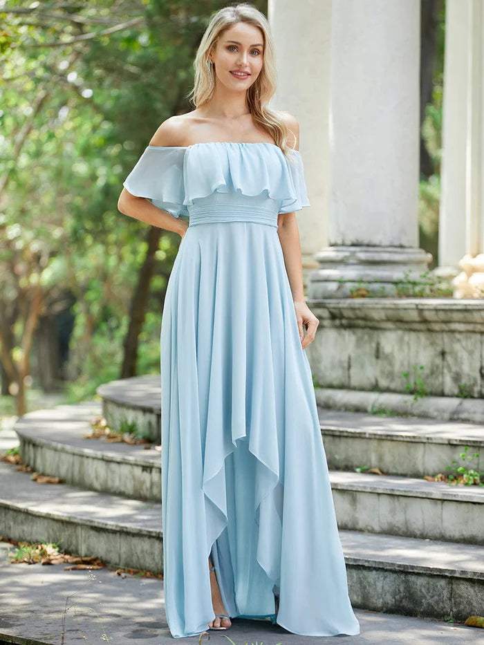 Woman wearing an elegant off-shoulder high-low chiffon bridesmaid dress, front view.
