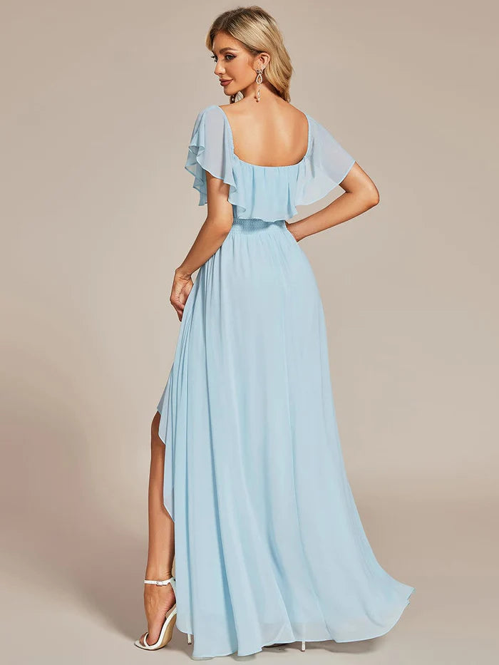 Side view of a woman in the high-low chiffon bridesmaid dress, showing the flowing skirt.