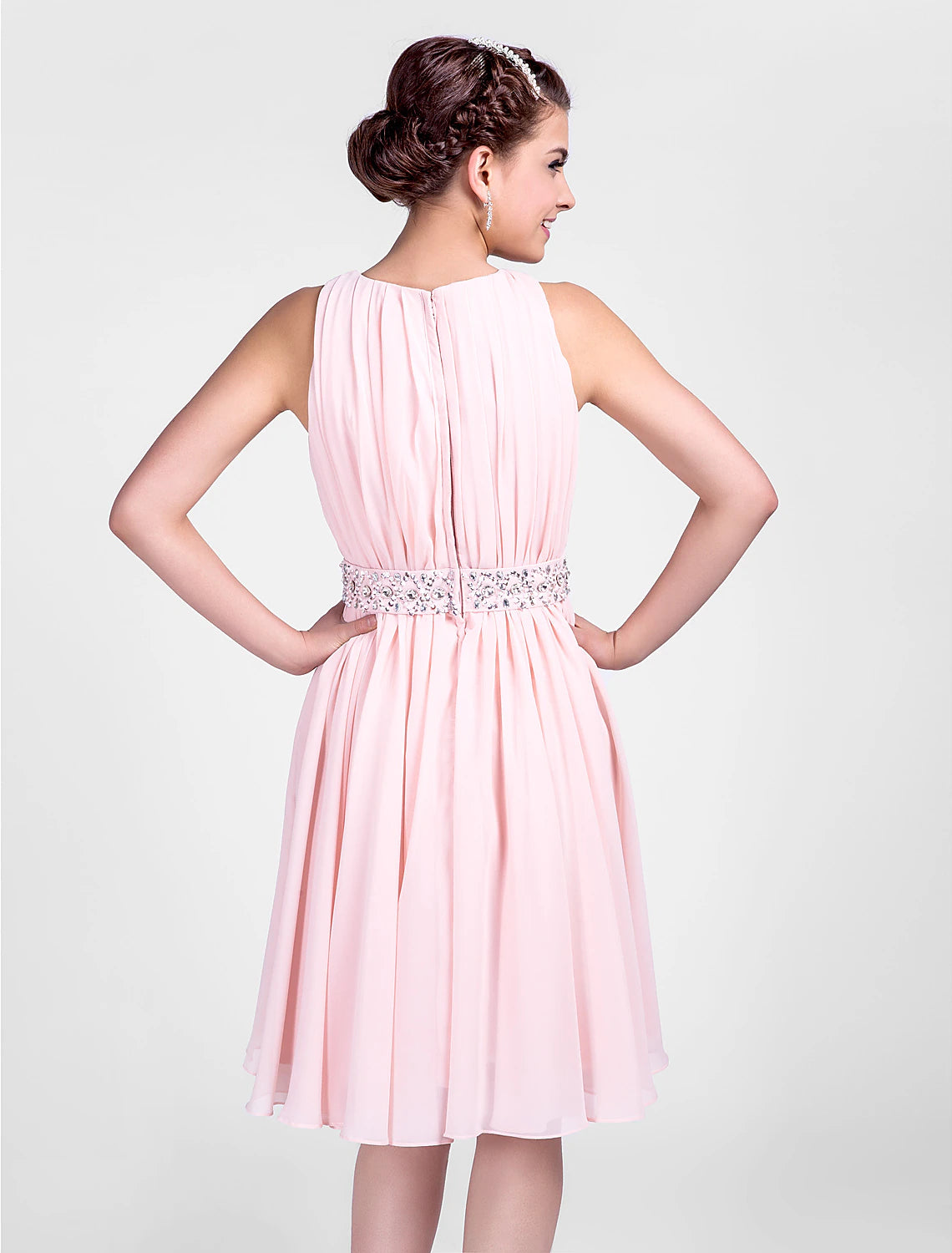 Close-up of the jewel neck and beaded details on the chiffon dress.