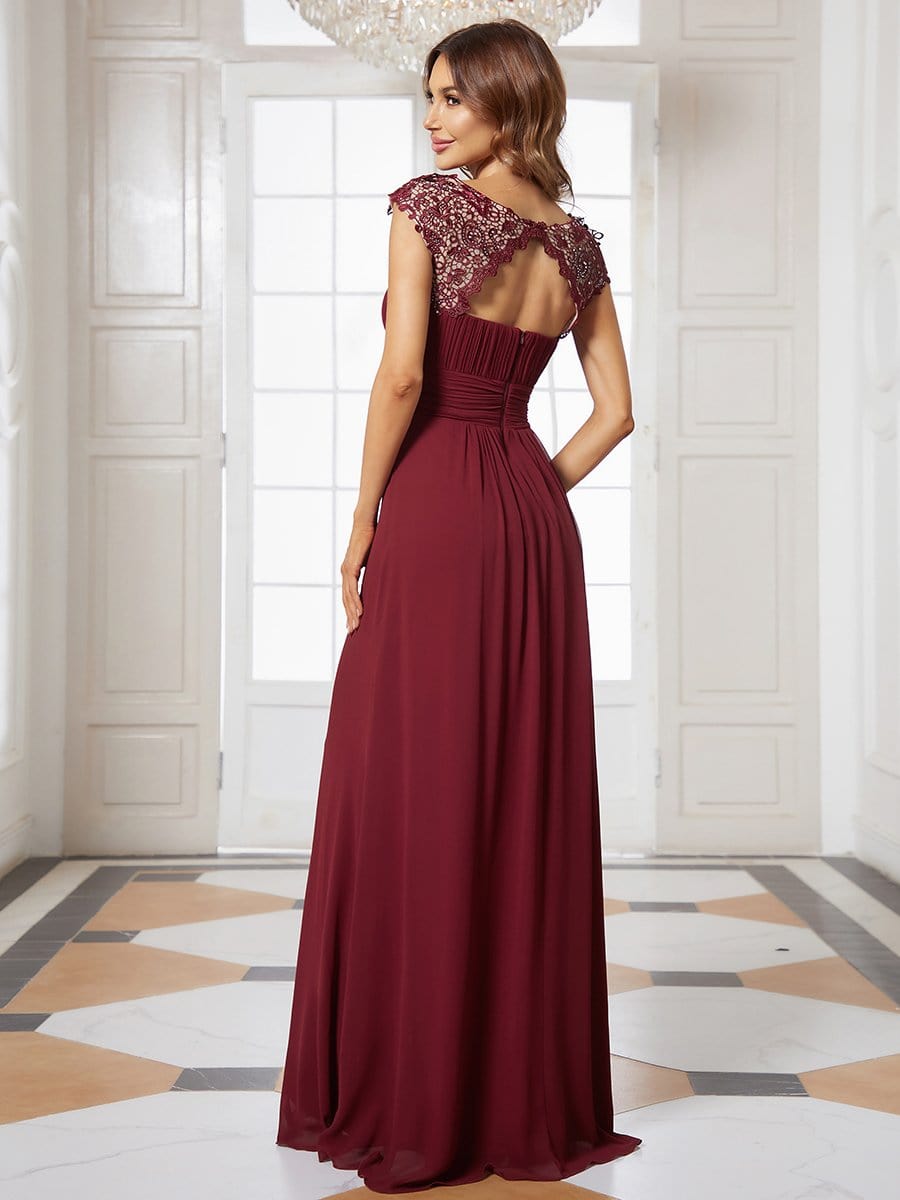 Model wearing a long chiffon bridesmaid dress with lace details.