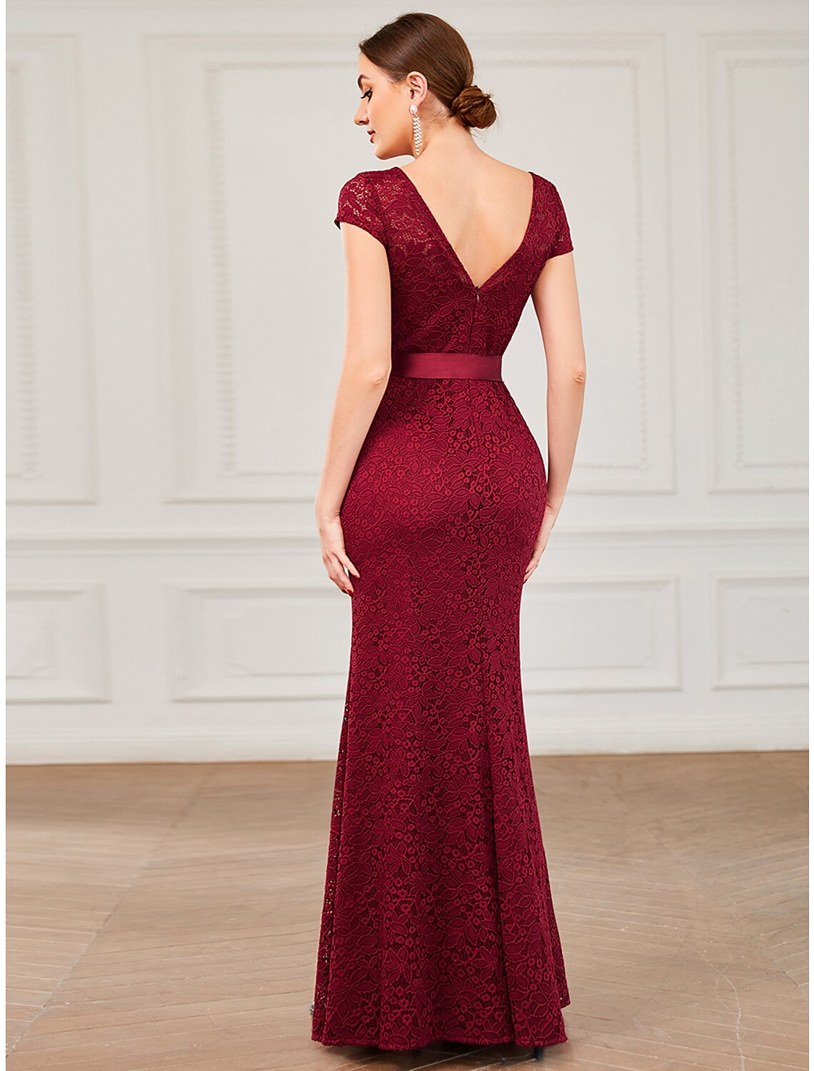 Back view of the Weitese mermaid trumpet evening gown, showing the lace V-back and strappy details.