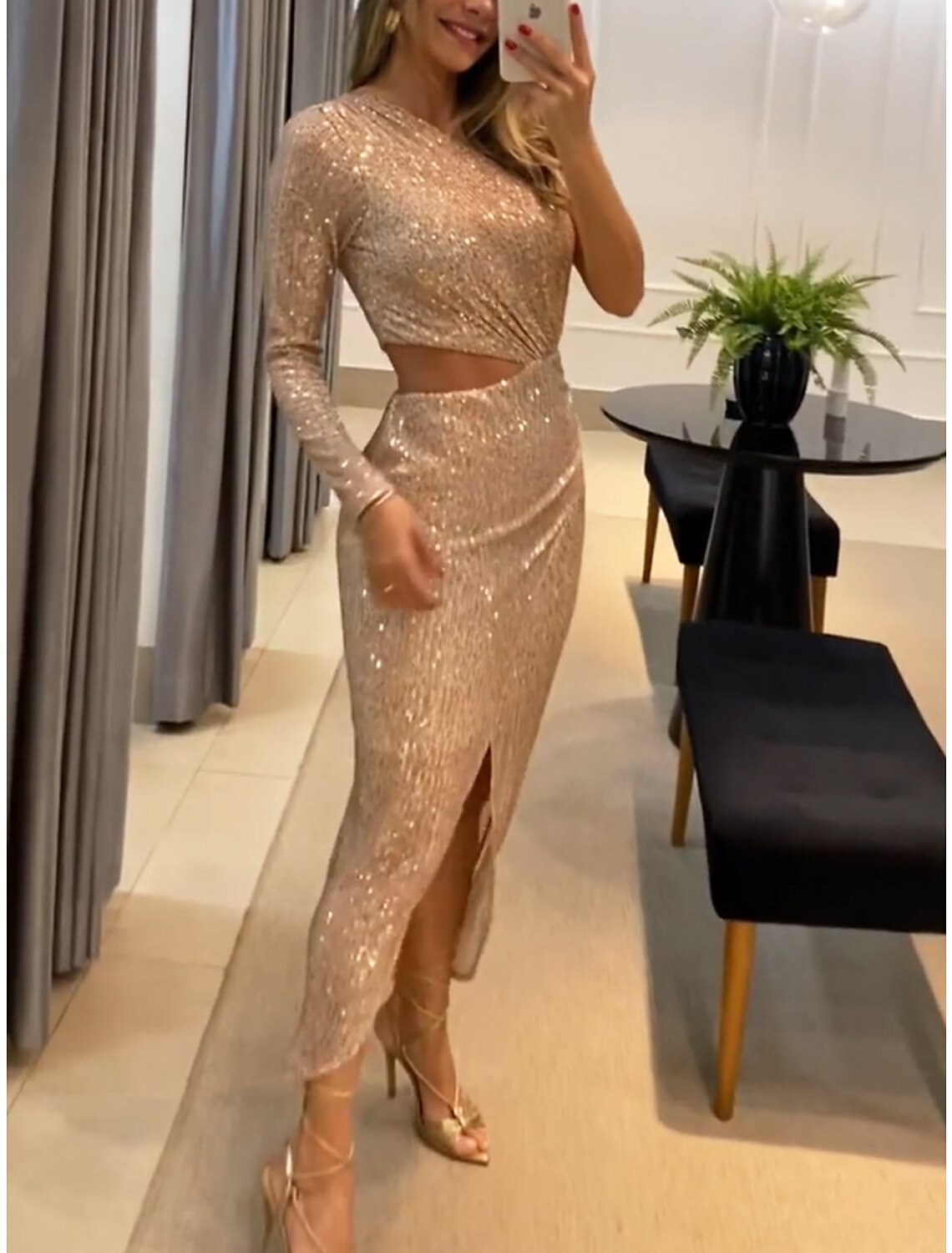 Back view of the Weitese one-shoulder long sleeve sequin gown, highlighting the flowing design.