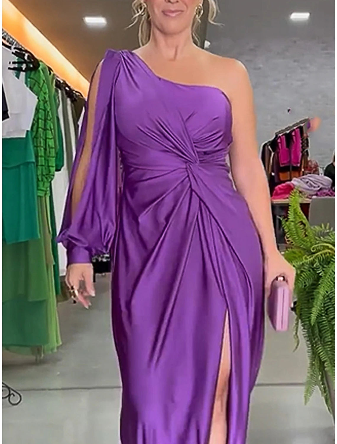 Close-up of the ruched detail and one-shoulder neckline on a purple satin maxi dress.